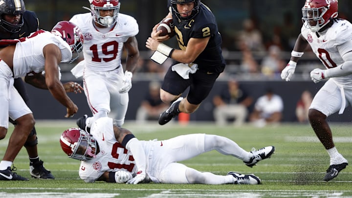 Oct 5, 2024; Nashville, Tennessee, USA; Vanderbilt Commodores quarterback Diego Pavia (2) jumps over Alabama Crimson Tide defensive back Malachi Moore (13) for a first down during the second half at FirstBank Stadium. Mandatory Credit: Butch Dill-Imagn Images Oct 5, 2024; Nashville, Tennessee, USA; Vanderbilt Commodores quarterback Diego Pavia (2) jumps over Alabama Crimson Tide defensive back Malachi Moore (13) for a first down during the second half at FirstBank Stadium. Mandatory Credit: Butch Dill-Imagn Images