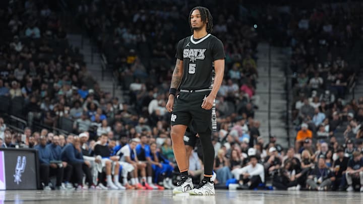 Apr 1, 2025; San Antonio, Texas, USA;  San Antonio Spurs guard Stephon Castle (5) looks on in the first half against the Orlando Magic at Frost Bank Center.