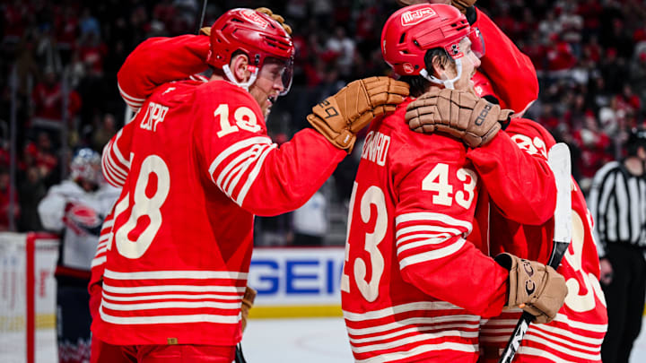 Dec 21, 2025; Detroit, Michigan, USA; Detroit Red Wings left wing John Leonard (43) celebrates with center Andrew Copp (18) and right wing Alex Debrincat (93) during the second period against the Washington Capitals at Little Caesars Arena. 