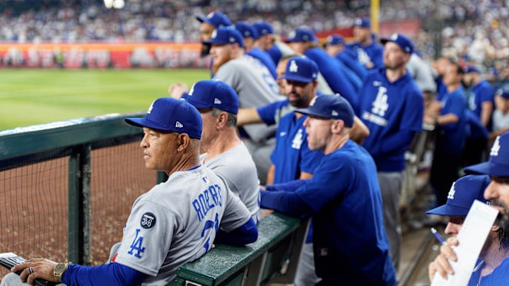 Sep 25, 2025; Phoenix, Arizona, USA; Los Angeles Dodgers manager Dave Roberts (30) watches on from the dugout during the eighth inning against the Arizona Diamondbacks at Chase Field. Mandatory Credit: Allan Henry-Imagn Images