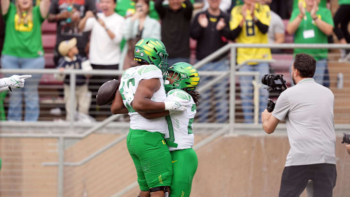 Sep 30, 2023; Stanford, California, USA; Oregon Ducks running back Jordan James (center right) celebrates with offensive lineman Ajani Cornelius (center left) after scoring a touchdown against the Stanford Cardinal during the second quarter at Stanford Stadium. Mandatory Credit: Darren Yamashita-USA TODAY Sports