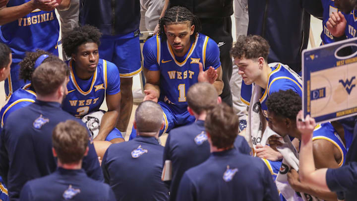 Jan 31, 2026; Morgantown, West Virginia, USA; West Virginia Mountaineers head coach Ross Hodge talks to his players during a timeout during the second half against the Baylor Bears at Hope Coliseum. Mandatory Credit: Ben Queen-Imagn Images