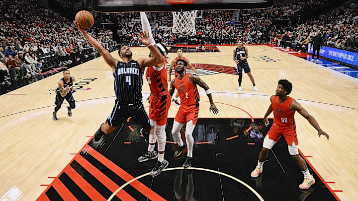Oct 27, 2023; Portland, Oregon, USA; Orlando Magic guard Jalen Suggs (4) drives to the basket during the first half against Portland Trail Blazers center Robert Williams III (35) at Moda Center. Mandatory Credit: Troy Wayrynen-Imagn Images Oct 27, 2023; Portland, Oregon, USA; Orlando Magic guard Jalen Suggs (4) drives to the basket during the first half against Portland Trail Blazers center Robert Williams III (35) at Moda Center. Mandatory Credit: Troy Wayrynen-Imagn Images