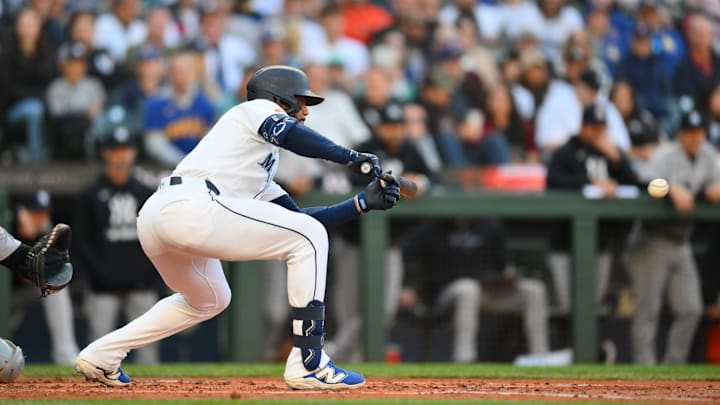May 12, 2025; Seattle, Washington, USA; Seattle Mariners right fielder Leody Taveras (4) bunts the ball during the second inning against the New York Yankees at T-Mobile Park. Mandatory Credit: Steven Bisig-Imagn Images