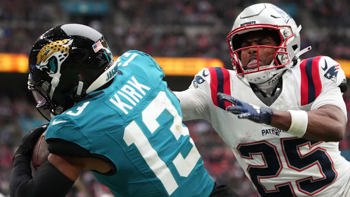 Oct 20, 2024; London, United Kingdom; Jacksonville Jaguars wide receiver Christian Kirk (13) attempts to catch the ball against New England Patriots cornerback Marcus Jones (25) in the second half of an NFL International Series game at Wembley Stadium. Mandatory Credit: Kirby Lee-Imagn Images