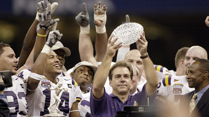 Jan. 4, 2004; New Orleans, LA, USA; Nick Saban, in blue, lifts the BCS National Championship Trophy after the Tigers' 21-14 victory over Oklahoma in the Nokia Sugar Bowl; Mandatory credit: Robert Deutsch-USA TODAY NETWORK