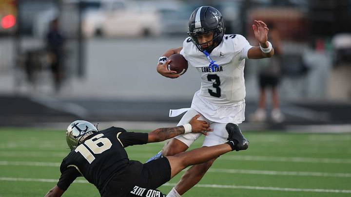 Frisco Lone Star quarterback Trey Wright makes a move on a Royse City defender in a Week 1 game.