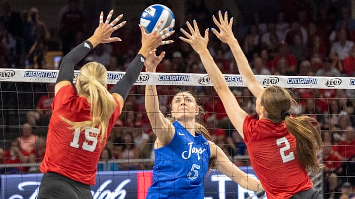 Nebraska middle blocker Andi Jackson and setter Bergen Reilly defend an attack from Creighton's Kiara Reinhardt. The Huskers will leave the state for the first time since August this weekend.