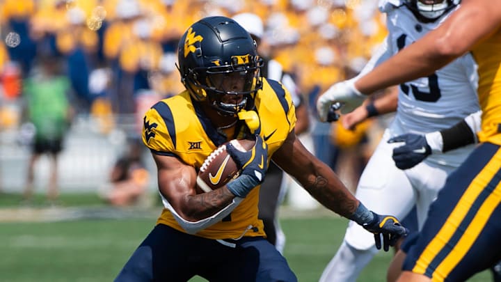 West Virginia running back Jahiem White carries the ball in the first half of an NCAA football game against Penn State, Saturday, August 31, 2024, in Morgantown, W. Va. West Virginia running back Jahiem White carries the ball in the first half of an NCAA football game against Penn State, Saturday, August 31, 2024, in Morgantown, W. Va.
