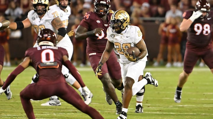 Sep 6, 2025; Blacksburg, Va.; Vanderbilt running back Sedrick Alexander (28) runs the ball against Virginia Tech safety Quentin Reddish (0). Sep 6, 2025; Blacksburg, Va.; Vanderbilt running back Sedrick Alexander (28) runs the ball against Virginia Tech safety Quentin Reddish (0).