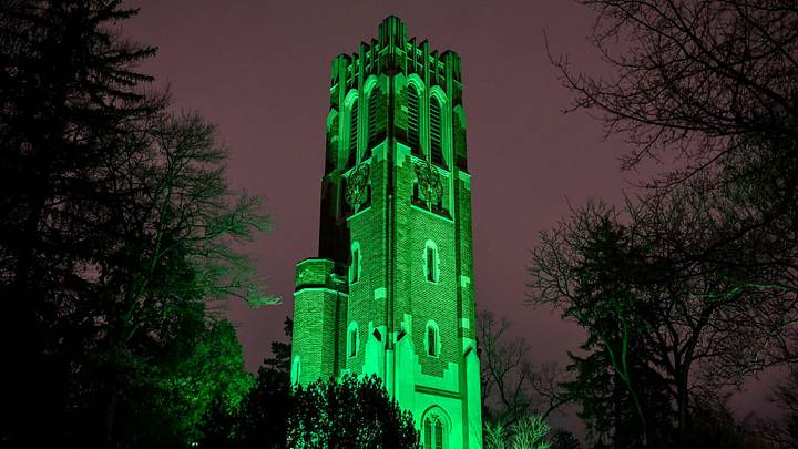 Green lights illuminate Beaumont Tower on Monday, Feb. 27, 2023, on the MSU campus in East Lansing. Before the green lights were turned on at 8:18 p.m., the carillon will played 'MSU Shadows.' The song was followed by eight bell tolls in honor and remembrance of the three killed and five students injured in the Feb. 13 tragedy.