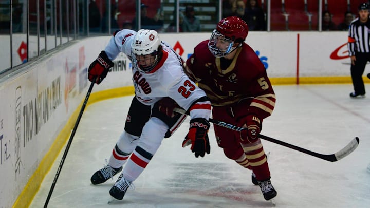 St. Cloud State hockey freshman Austin Burnevik picks up the puck behind the Boston College goal during a game Nov. 2, 2024 at home in the Herb Brooks National Hockey Center. The Huskies lost 2-1.