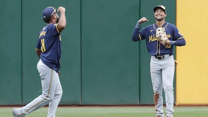 Sep 26, 2024; Pittsburgh, Pennsylvania, USA;  Milwaukee Brewers left fielder Jackson Chourio (11) and center fielder Blake Perkins (16) celebrate in the outfield after defeating the Pittsburgh Pirates at PNC Park. The Brewers won 5-2. Mandatory Credit: Charles LeClaire-Imagn Images