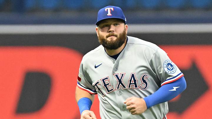 Rangers first baseman Jake Burger (21) warms up before the start of the game against the Rays. Credit: Jonathan Dyer-Imagn I