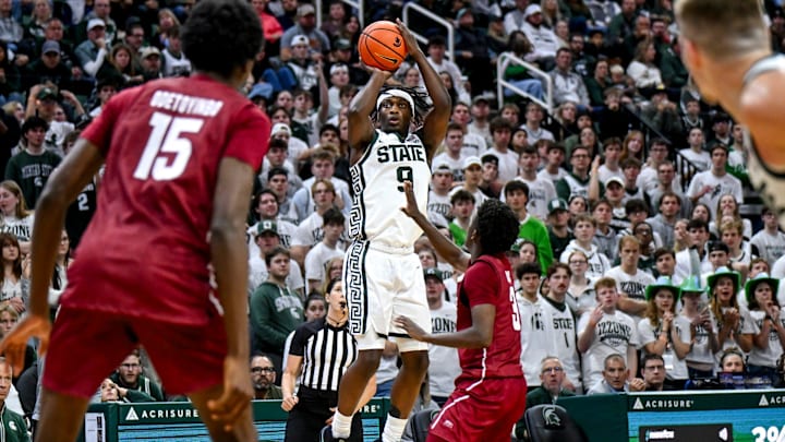 Michigan State's Trey Fort, left, makes a 3-pointer as Colgate's Jalen Cox defends during the second half on Monday, Nov. 3, 2025, at the Breslin Center in East Lansing.