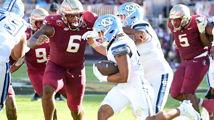 Nov 2, 2024; Tallahassee, Florida, USA;  Florida State Seminoles defensive tackle Darrell Jackson Jr (6) pursues North Carolina Tarheels running back Davion Gause (21) in the second quarter at Doak S. Campbell Stadium. Mandatory Credit: Robert Myers-Imagn Images