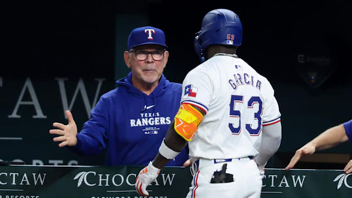 Sep 18, 2024; Arlington, Texas, USA;  Texas Rangers right fielder Adolis Garcia (53) celebrates with Texas Rangers manager Bruce Bochy (15) after hitting a two-run home run during the sixth inning against the Toronto Blue Jays at Globe Life Field. 