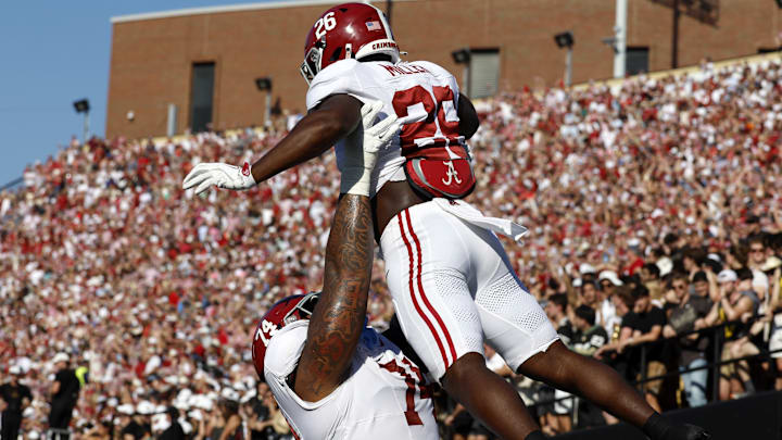 Oct 5, 2024; Nashville, Tennessee, USA; Alabama Crimson Tide running back Jam Miller (26) celebrates with offensive lineman Kadyn Proctor (74) after scoring a touchdown against the Vanderbilt Commodores during the first half at FirstBank Stadium.