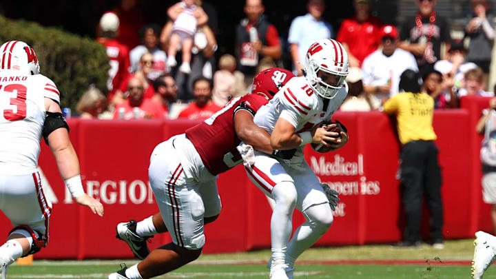 Sep 13, 2025; Tuscaloosa, Alabama, USA; Wisconsin Badgers quarterback Danny O'Neil (18) is sacked by Alabama Crimson Tide defensive lineman London Simmons (90) during the second quarter at Saban Field at Bryant-Denny Stadium. Mandatory Credit: David Leong-Imagn Images