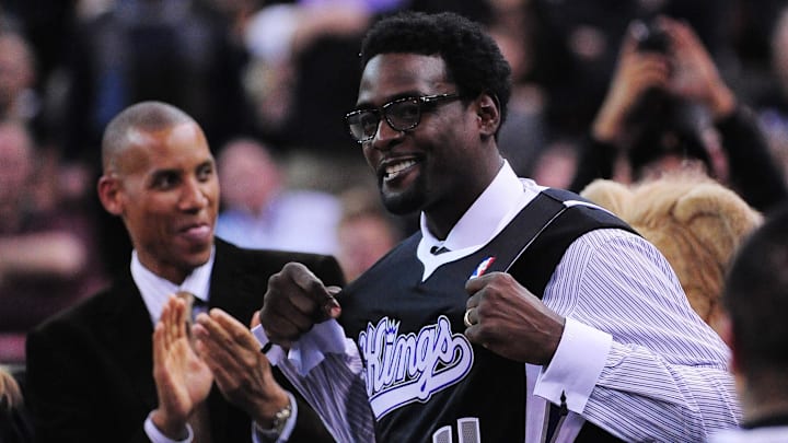 February 9, 2012; Sacramento, CA, USA; Sacramento Kings former player Chris Webber (right) holds his jersey as former Indiana Pacers player Reggie Miller (left) looks on during the first quarter against the Oklahoma City Thunder at Power Balance Pavilion. Mandatory Credit: Kyle Terada-Imagn Images