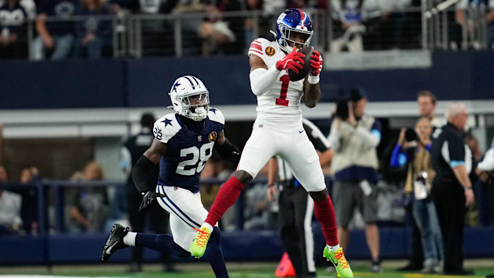 Nov 28, 2024; Arlington, Texas, USA;  New York Giants wide receiver Malik Nabers (1) catches a pass as Dallas Cowboys safety Malik Hooker (28) gives chase during the first half at AT& T Stadium.  