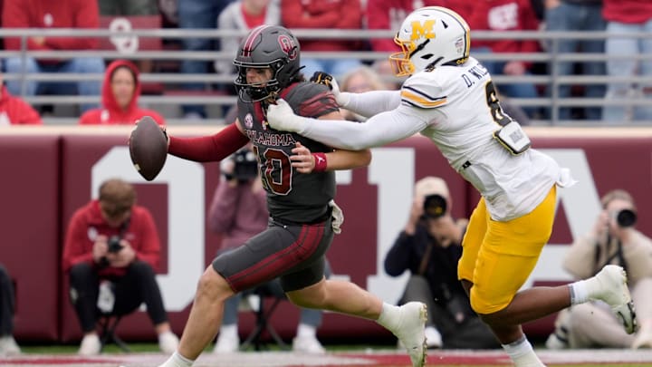 Missouri Tigers defensive end Damon Wilson II (8) brings down Oklahoma Sooners quarterback John Mateer (10)