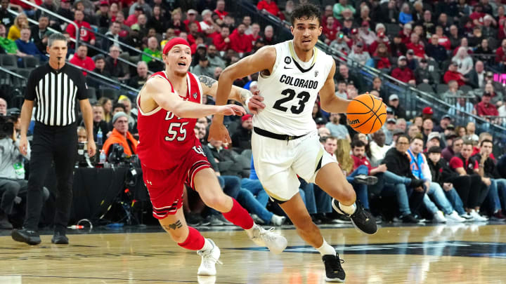Colorado Buffaloes forward Tristan da Silva (23) dribbles away from Utah Utes guard Gabe Madsen (55) during the first half at T-Mobile Arena. Colorado Buffaloes forward Tristan da Silva (23) dribbles away from Utah Utes guard Gabe Madsen (55) during the first half at T-Mobile Arena.