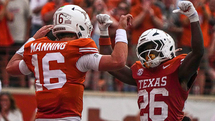Texas Longhorns quarterback Arch Manning (16) and running back Quintrevion Wisner (26) celebrate a touchdown by Manning during the game against UTSA at Darrell K Royal-Texas Memorial Stadium in Austin Saturday, Sept. 14, 2024.