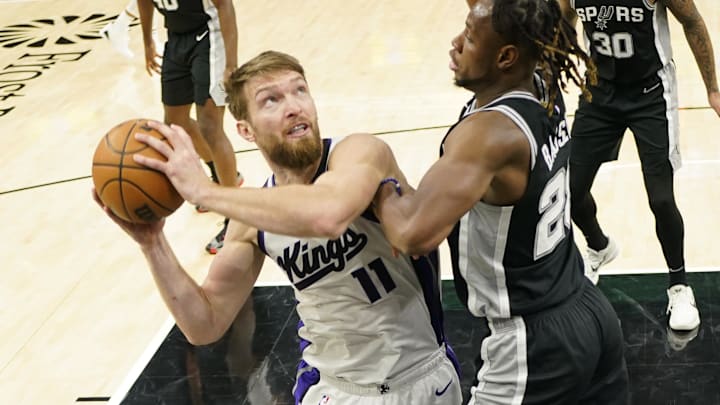 Dec 6, 2024; San Antonio, Texas, USA; Sacramento Kings center Domantas Sabonis (11) looks to shoot over San Antonio Spurs center Charles Bassey (28) during the first half at Frost Bank Center. Mandatory Credit: Scott Wachter-Imagn Images