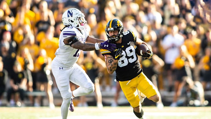 Iowa wide receiver Nico Ragaini (89) gets tackled by Northwestern defensive back Garnett Hollis, Jr. in 2022. Iowa wide receiver Nico Ragaini (89) gets tackled by Northwestern defensive back Garnett Hollis, Jr. in 2022.
