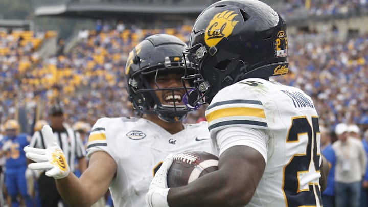Oct 12, 2024; Pittsburgh, Pennsylvania, USA; California Golden Bears wide receiver Mikey Matthews (left) congratulates running back Jaivian Thomas (25) on his touchdown against the Pittsburgh Panthers during the first quarter at Acrisure Stadium. Mandatory Credit: Charles LeClaire-Imagn Images Oct 12, 2024; Pittsburgh, Pennsylvania, USA; California Golden Bears wide receiver Mikey Matthews (left) congratulates running back Jaivian Thomas (25) on his touchdown against the Pittsburgh Panthers during the first quarter at Acrisure Stadium. Mandatory Credit: Charles LeClaire-Imagn Images