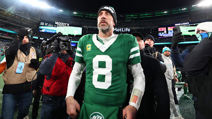 Jan 5, 2025; East Rutherford, New Jersey, USA; New York Jets quarterback Aaron Rodgers (8) walks on the field after the Jets win over the Miami Dolphins at MetLife Stadium. Mandatory Credit: Ed Mulholland-Imagn Images