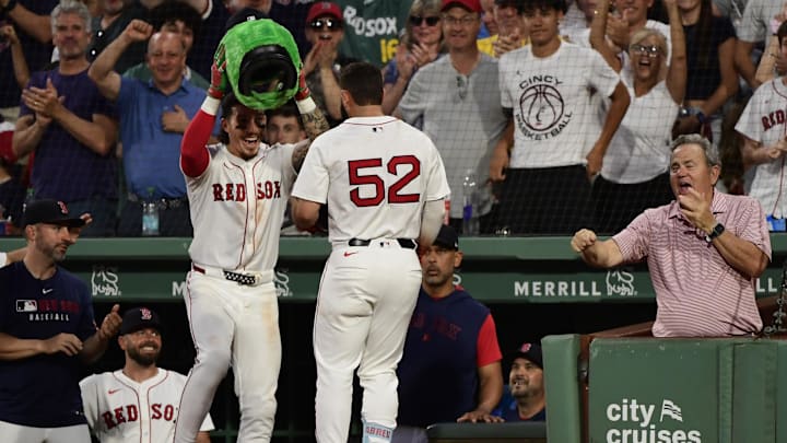 Jun 30, 2025; Boston, Massachusetts, USA; Boston Red Sox left fielder Jarren Duran (16) places the Wally helmet on right fielder Wilyer Abreu (52) after hitting an inside the park home run during the fifth inning against the Cincinnati Reds at Fenway Park. Mandatory Credit: Bob DeChiara-Imagn Images Jun 30, 2025; Boston, Massachusetts, USA; Boston Red Sox left fielder Jarren Duran (16) places the Wally helmet on right fielder Wilyer Abreu (52) after hitting an inside the park home run during the fifth inning against the Cincinnati Reds at Fenway Park. Mandatory Credit: Bob DeChiara-Imagn Images
