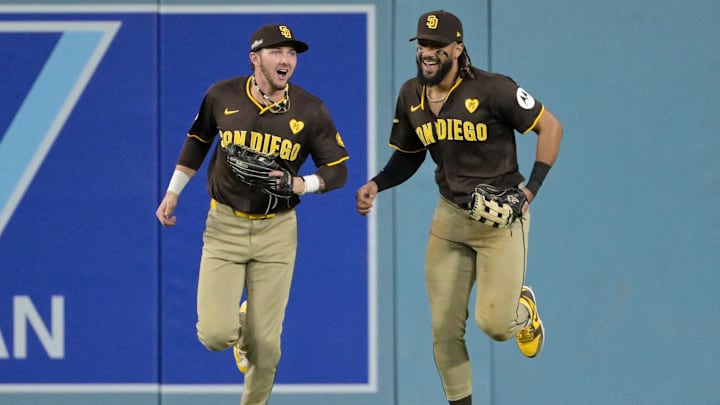 Oct 6, 2024; Los Angeles, California, USA; San Diego Padres outfielder Jackson Merrill (3) and outfielder Fernando Tatis Jr. (23) react in the sixth inning against the Los Angeles Dodgers during game two of the NLDS for the 2024 MLB Playoffs at Dodger Stadium. Mandatory Credit: Jayne Kamin-Oncea-Imagn Images