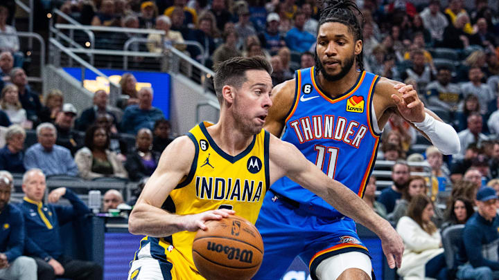 Mar 31, 2023; Indianapolis, Indiana, USA;  Indiana Pacers guard T.J. McConnell (9) dribbles the ball while Oklahoma City Thunder guard Isaiah Joe (11) defends in the first quarter at Gainbridge Fieldhouse. Mandatory Credit: Trevor Ruszkowski-Imagn Images