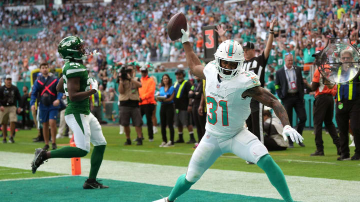 Miami Dolphins running back Raheem Mostert spikes the ball after scoring a touchdown past New York Jets safety Tony Adams (22) during the first half of Miami's 30-0 victory at Hard Rock Stadium last December. Miami Dolphins running back Raheem Mostert spikes the ball after scoring a touchdown past New York Jets safety Tony Adams (22) during the first half of Miami's 30-0 victory at Hard Rock Stadium last December.