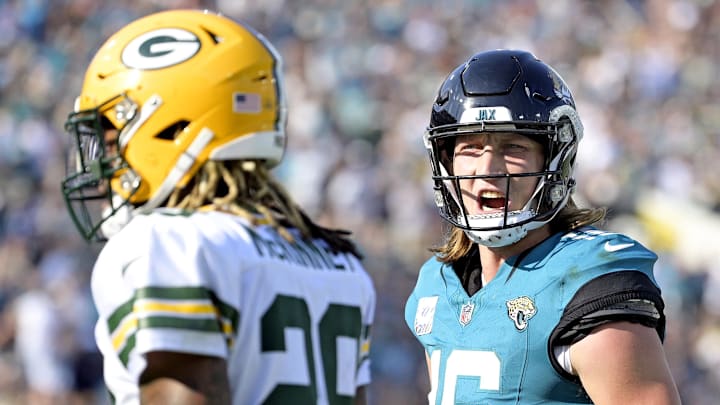 Oct 27, 2024; Jacksonville, Florida, USA; Jacksonville Jaguars quarterback Trevor Lawrence (16) speaks to Green Bay Packers safety Xavier McKinney (29) after a touchdown pass during the fourth quarter at EverBank Stadium. Mandatory Credit: Melina Myers-Imagn Images
