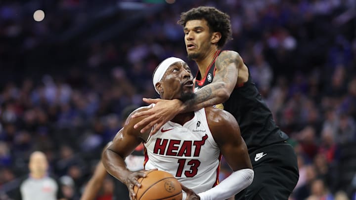 Feb 26, 2026; Philadelphia, Pennsylvania, USA; Miami Heat center Bam Adebayo (13) drives against Philadelphia 76ers forward Dominick Barlow (25) during the first quarter at Xfinity Mobile Arena. Mandatory Credit: Bill Streicher-Imagn Images