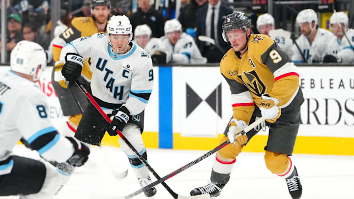 Mar 19, 2026; Las Vegas, Nevada, USA; Utah Mammoth right wing Clayton Keller (9) keeps the puck away from Vegas Golden Knights center Jack Eichel (9) during the second period at T-Mobile Arena. Mandatory Credit: Stephen R. Sylvanie-Imagn Images
