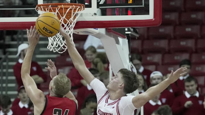 Oct 30, 2024; Madison, Wisconsin: Wisconsin forward Nolan Winter (31) blocks a shot by UW-River Falls forward Drew Adams (24) during the second half of their preseason game Wednesday, October 30, 2024 at the Kohl Center in Madison, Wisconsin. Mark Hoffman/Imagn Images Oct 30, 2024; Madison, Wisconsin: Wisconsin forward Nolan Winter (31) blocks a shot by UW-River Falls forward Drew Adams (24) during the second half of their preseason game Wednesday, October 30, 2024 at the Kohl Center in Madison, Wisconsin. Mark Hoffman/Imagn Images