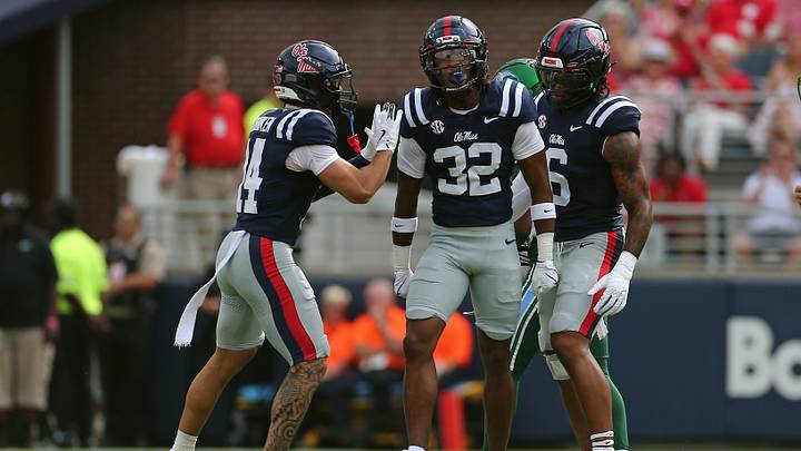 Sep 20, 2025; Oxford, Mississippi, USA; Mississippi Rebels defensive back Kapena Gushiken (14) and linebacker TJ Dottery (6) react with defensive back Chris Graves Jr. (32) after a defensive stop during the first quarter against the Tulane Green Wave at Vaught-Hemingway Stadium. Mandatory Credit: Petre Thomas-Imagn Images Sep 20, 2025; Oxford, Mississippi, USA; Mississippi Rebels defensive back Kapena Gushiken (14) and linebacker TJ Dottery (6) react with defensive back Chris Graves Jr. (32) after a defensive stop during the first quarter against the Tulane Green Wave at Vaught-Hemingway Stadium. Mandatory Credit: Petre Thomas-Imagn Images