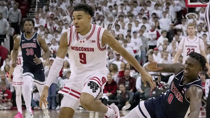Arizona guard Jaden Bradley (0) fouls Wisconsin guard John Tonje (9) during the second half of their game Friday, November 15, 2024 at the Kohl Center in Madison, Wisconsin.