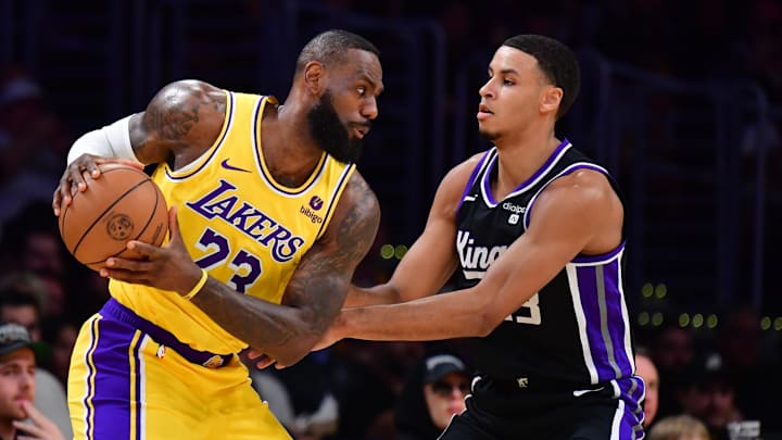 Mar 6, 2024; Los Angeles, California, USA;  Los Angeles Lakers forward LeBron James (23) moves the ball against Sacramento Kings forward Keegan Murray (13) during the first half at Crypto.com Arena. Mandatory Credit: Gary A. Vasquez-Imagn Images