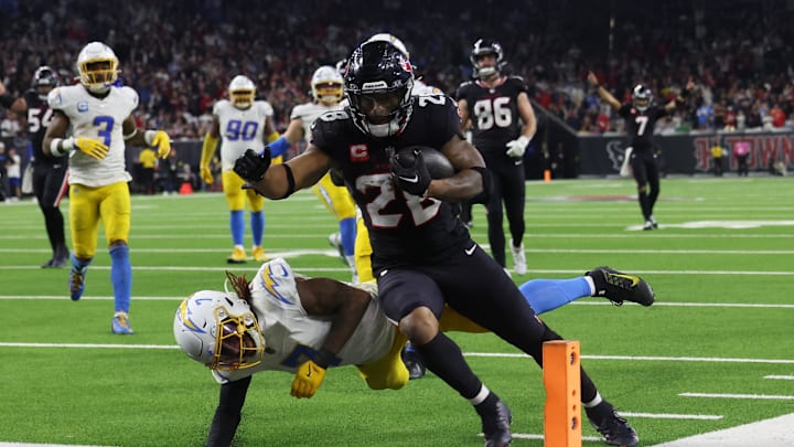 Jan 11, 2025; Houston, Texas, USA;  Houston Texans running back Joe Mixon (28) scores a touchdown against the Los Angeles Chargers in the fourth quarter in an AFC wild card game at NRG Stadium. Mandatory Credit: Thomas Shea-Imagn Images