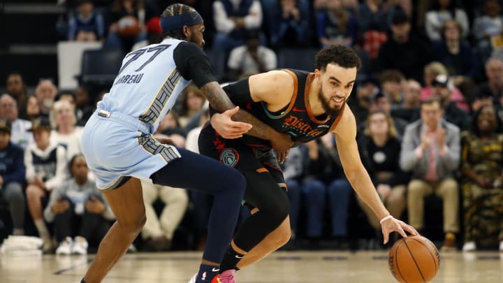 Mar 12, 2024; Memphis, Tennessee, USA; Washington Wizards guard Tyus Jones (5) dribbles the ball up the court as Memphis Grizzlies guard Dejon Jarreau (77) defends during the first half at FedExForum. Mandatory Credit: Petre Thomas-USA TODAY Sports Mar 12, 2024; Memphis, Tennessee, USA; Washington Wizards guard Tyus Jones (5) dribbles the ball up the court as Memphis Grizzlies guard Dejon Jarreau (77) defends during the first half at FedExForum. Mandatory Credit: Petre Thomas-USA TODAY Sports