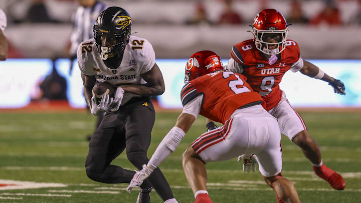Oct 11, 2025; Salt Lake City, Utah, USA; Arizona State Sun Devils wide receiver Malik McClain (12) runs after a catch against Utah Utes cornerback Smith Snowden (2) and cornerback Elijah Davis (9) during the third quarter at Rice-Eccles Stadium. Mandatory Credit: Rob Gray-Imagn Images