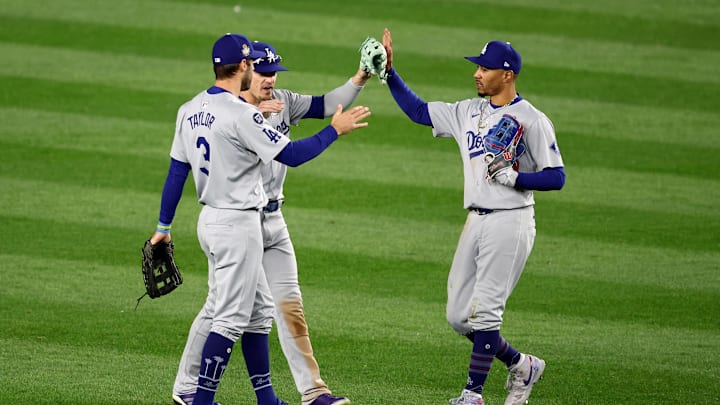 Oct 28, 2024; New York, New York, USA; Los Angeles Dodgers outfielders Chris Taylor (3), Enrique Hernandez (8) and Mookie Betts (50) celebrate after winning Game 3 of the 2024 MLB World Series against the New York Yankees at Yankee Stadium. Oct 28, 2024; New York, New York, USA; Los Angeles Dodgers outfielders Chris Taylor (3), Enrique Hernandez (8) and Mookie Betts (50) celebrate after winning Game 3 of the 2024 MLB World Series against the New York Yankees at Yankee Stadium.