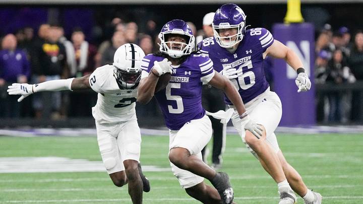 Northwestern Wildcats running back Caleb Komolafe (5) runs the ball against the Penn State Nittany Lions during the second half at New Ryan Field.