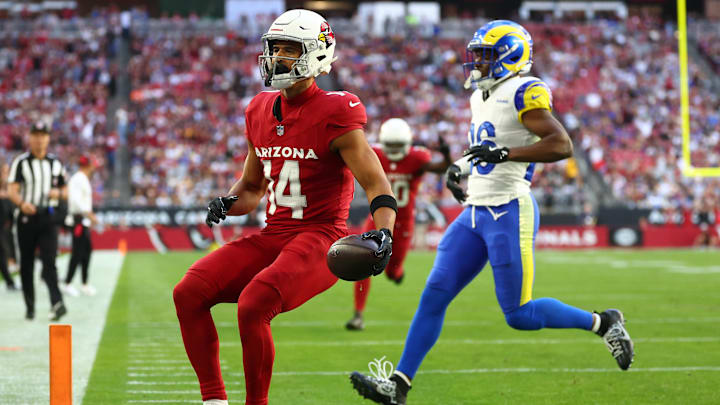 Dec 7, 2025; Glendale, Arizona, USA; Arizona Cardinals wide receiver Michael Wilson (14) runs for a touchdown after a catch against Los Angeles Rams safety Kamren Kinchens (26) during the first half at State Farm Stadium. Mandatory Credit: Mark J. Rebilas-Imagn Images Dec 7, 2025; Glendale, Arizona, USA; Arizona Cardinals wide receiver Michael Wilson (14) runs for a touchdown after a catch against Los Angeles Rams safety Kamren Kinchens (26) during the first half at State Farm Stadium. Mandatory Credit: Mark J. Rebilas-Imagn Images