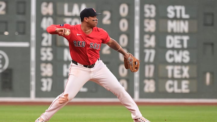 Aug 23, 2024; Boston, Massachusetts, USA; Boston Red Sox third baseman Rafael Devers (11) makes a throw for an out to end the first inning against the Arizona Diamondbacks at Fenway Park. Mandatory Credit: Eric Canha-Imagn Images